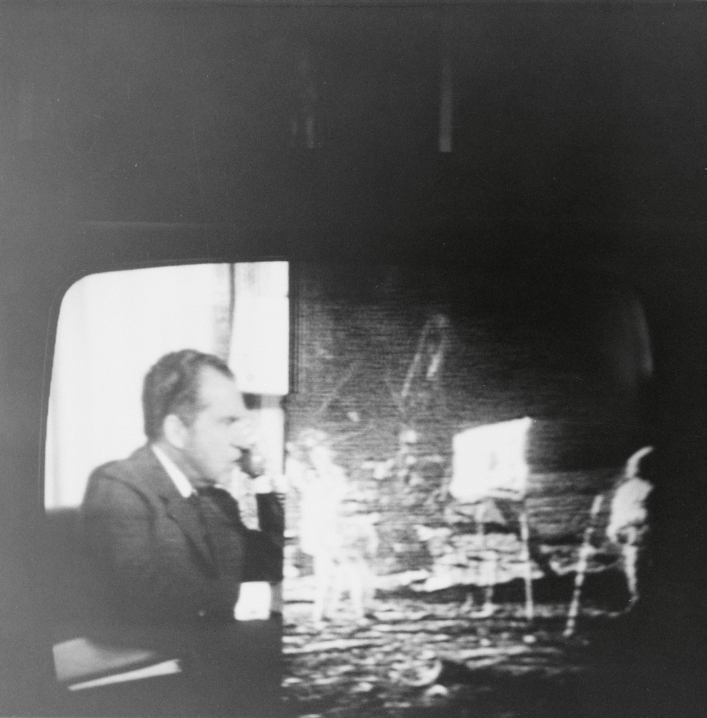 (TELEVISION) Small album with 35 snapshots of a television screen as Apollo 11 made its historic moon landing.
